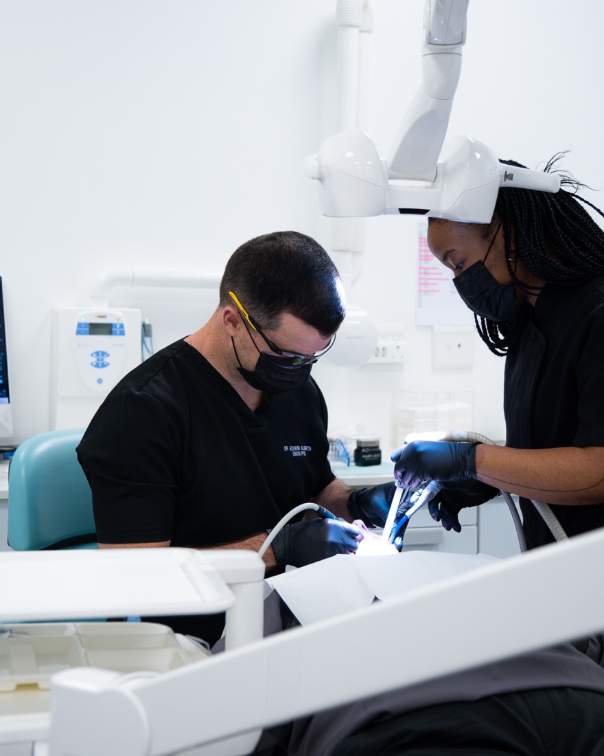 Dr Alberts and assistant treating a patient