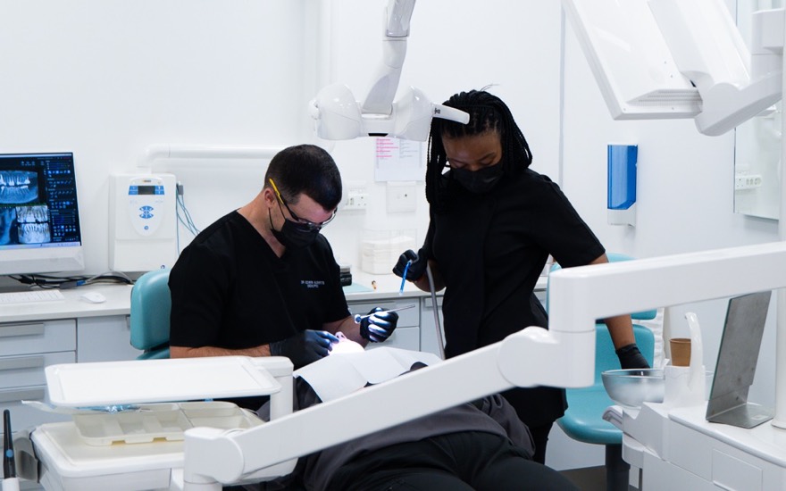 Dr Edwin Alberts and his assistant examining a patient during a routine dental check-up at Melrose Dental Studio